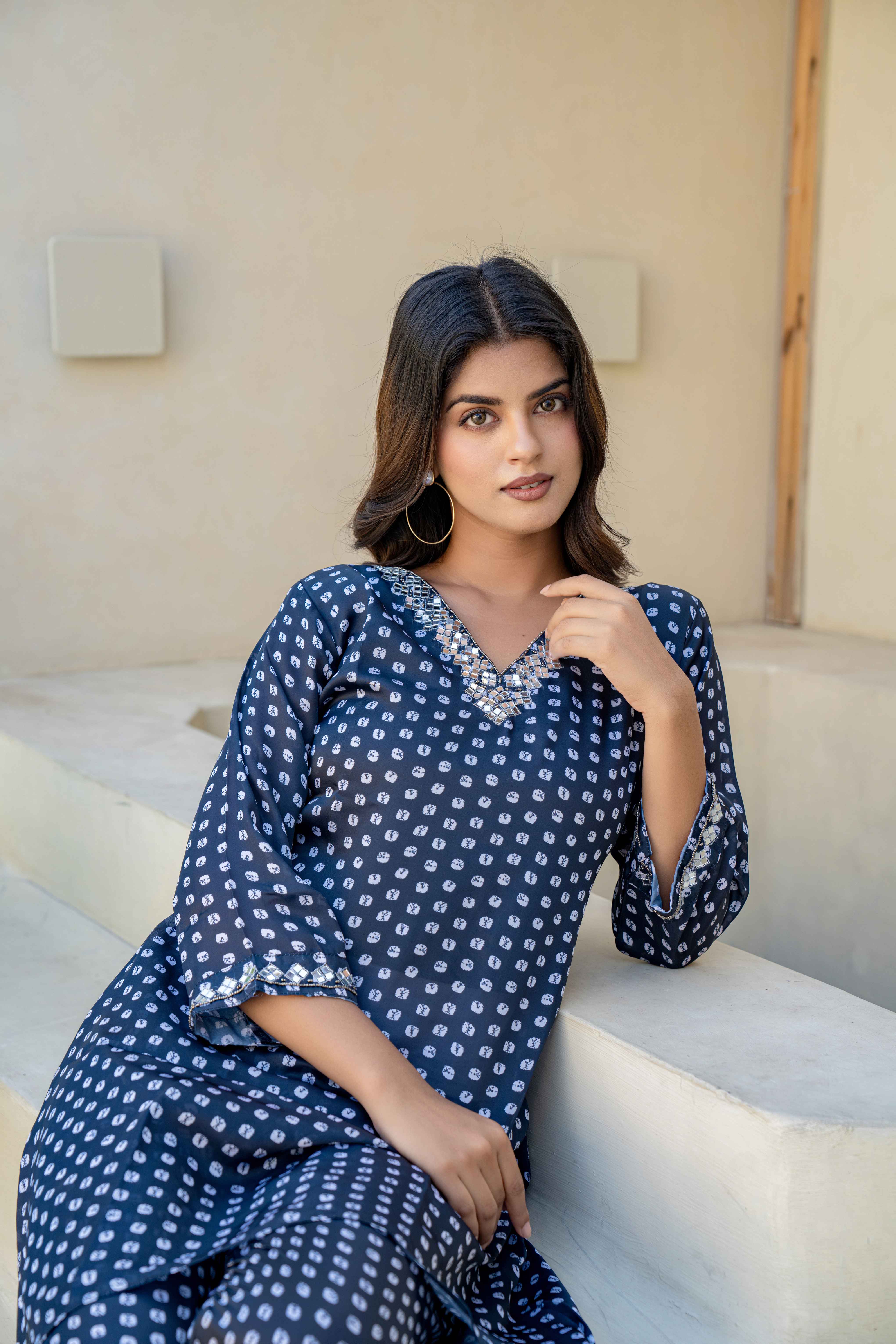 Navy Blue Printed High-Low Kurti Set with Embellished Neckline sitting pose view